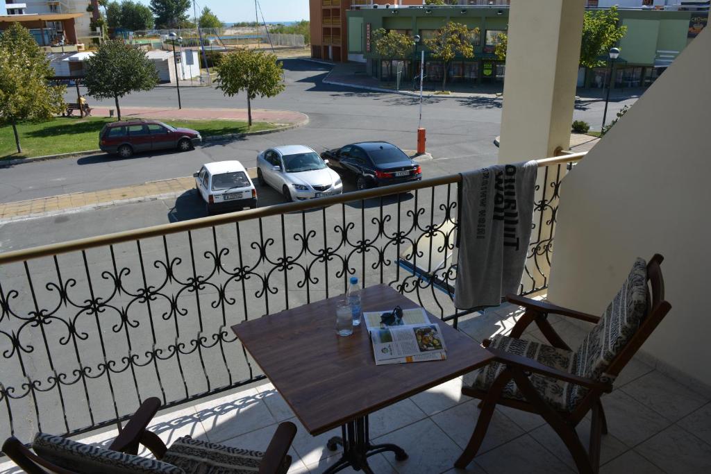 a table and chairs on a balcony with a view of a street at Lotus Family Hotel - Free Parking in Sunny Beach