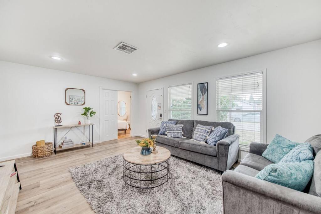 a living room with two couches and a coffee table at Charming Modern 3BR Fresno House in Fresno