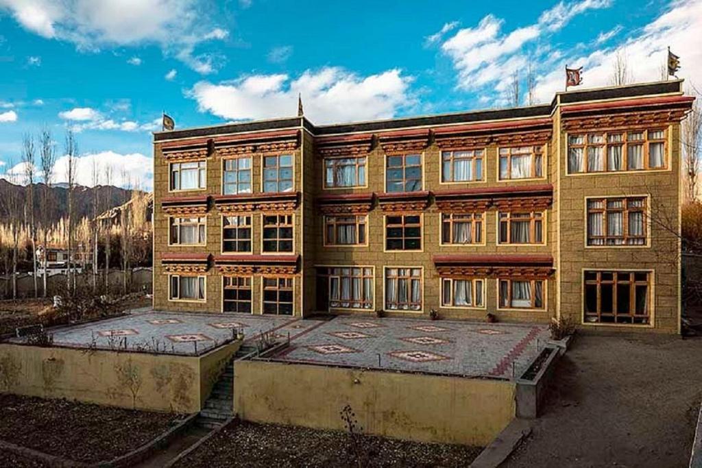a large building with a lot of windows at Hotel Alpine Ladakh in Leh
