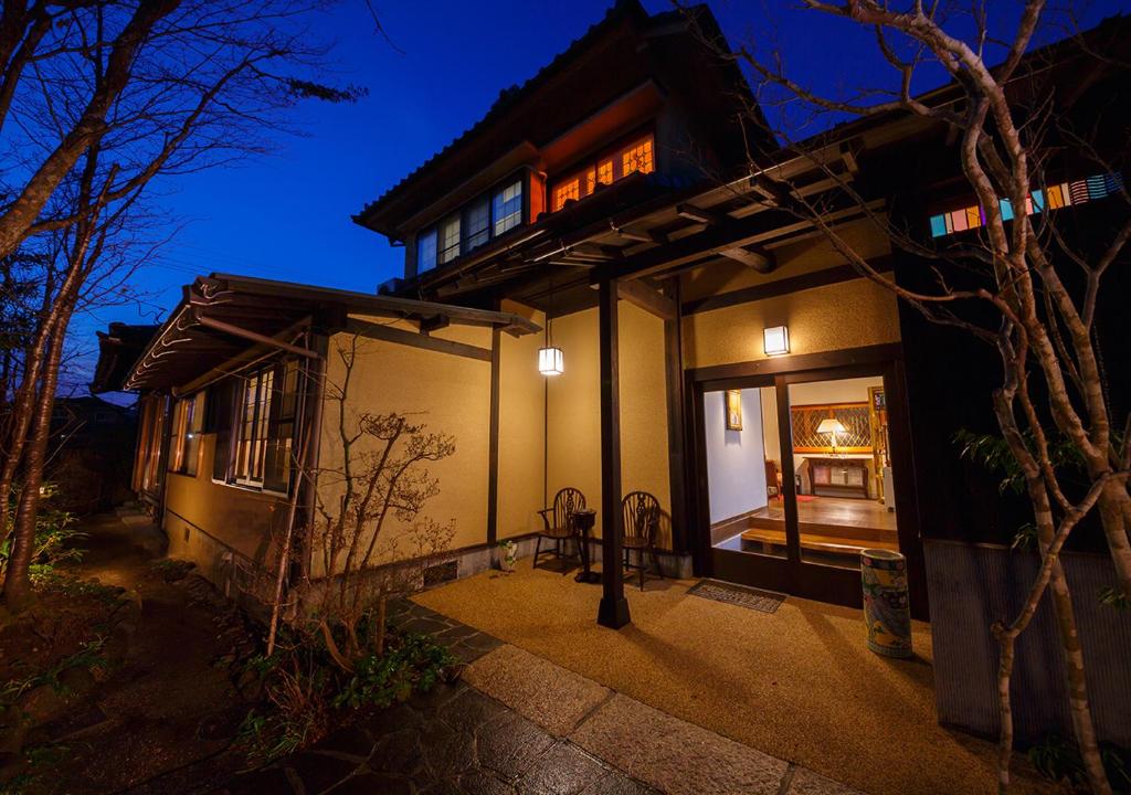 a building with a sign on it at night at Kannomori in Yufu