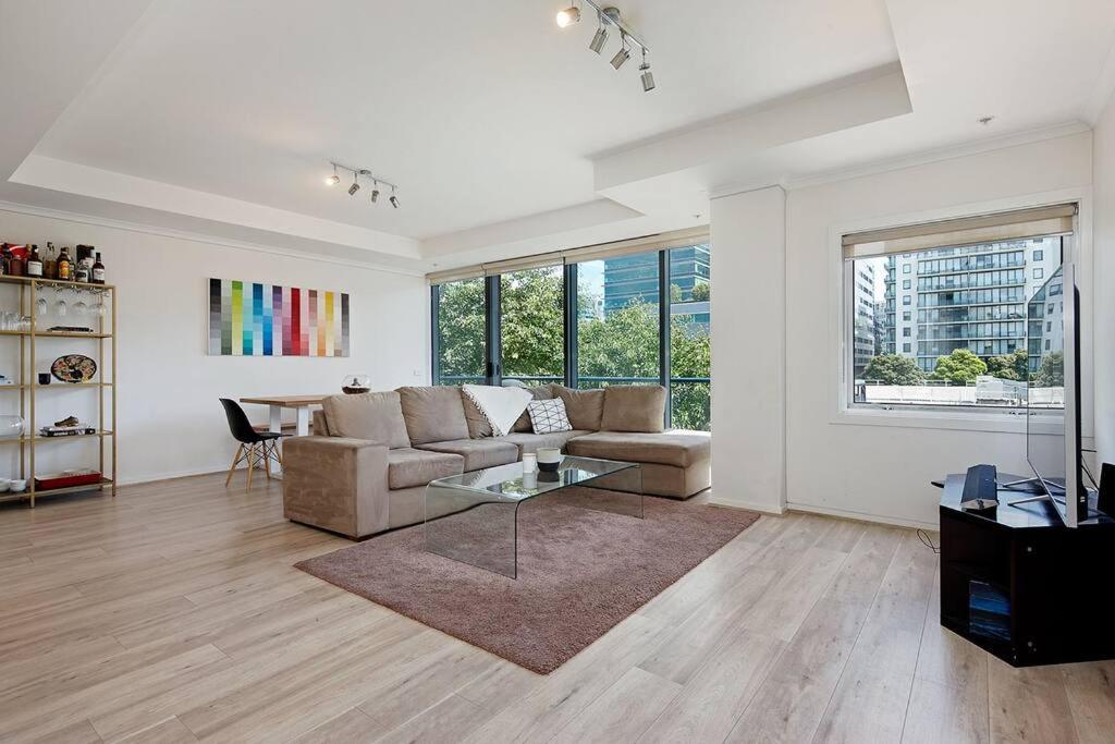 a living room with a couch and a table at Spacious apartment minutes from the CBD in Melbourne