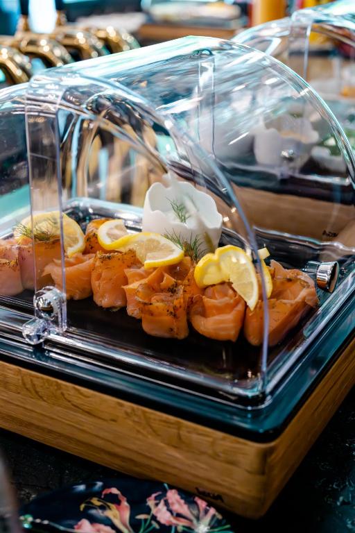 a tray of shrimp with lemon slices on it at O11 Boutique Hotel Vienna in Vienna
