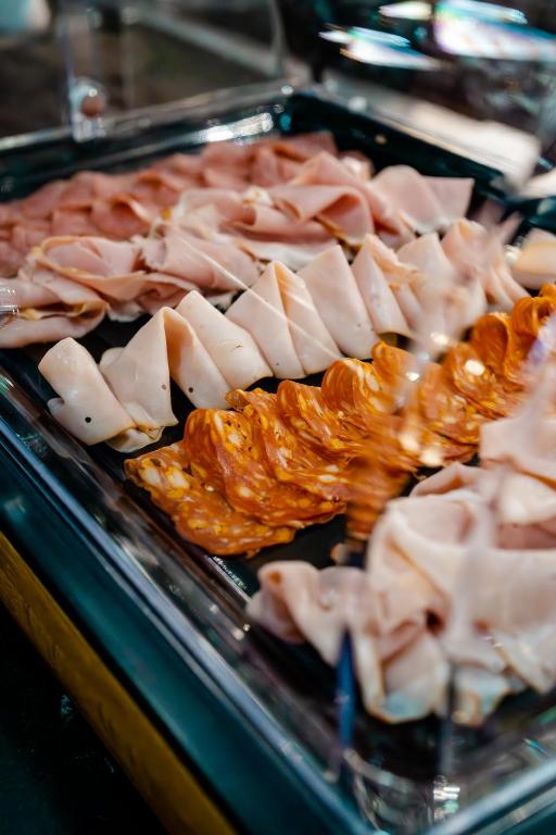 a tray of food with meats and pretzels at O11 Boutique Hotel Vienna in Vienna
