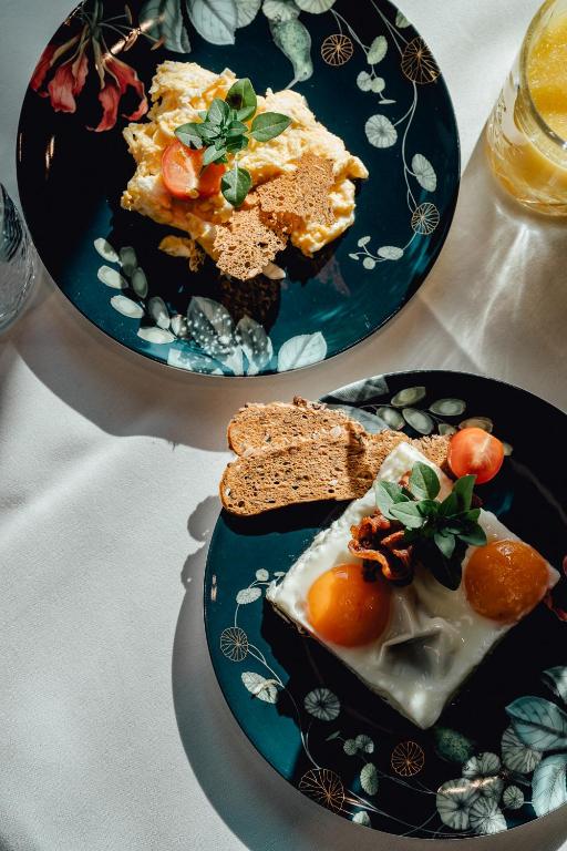 two plates of food sitting on a table at O11 Boutique Hotel Vienna in Vienna