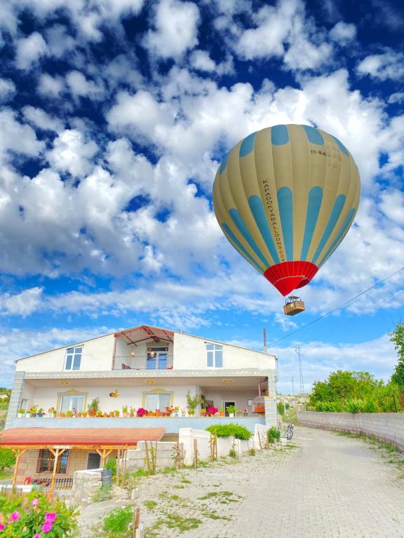 a hot air balloon flying over a house at Unique villa in Cappadocia in Urgup