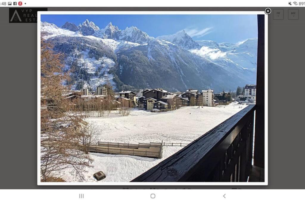 a view of a snow covered mountain from a window at Bel appartement entier en style Chalet à Chamonix in Chamonix