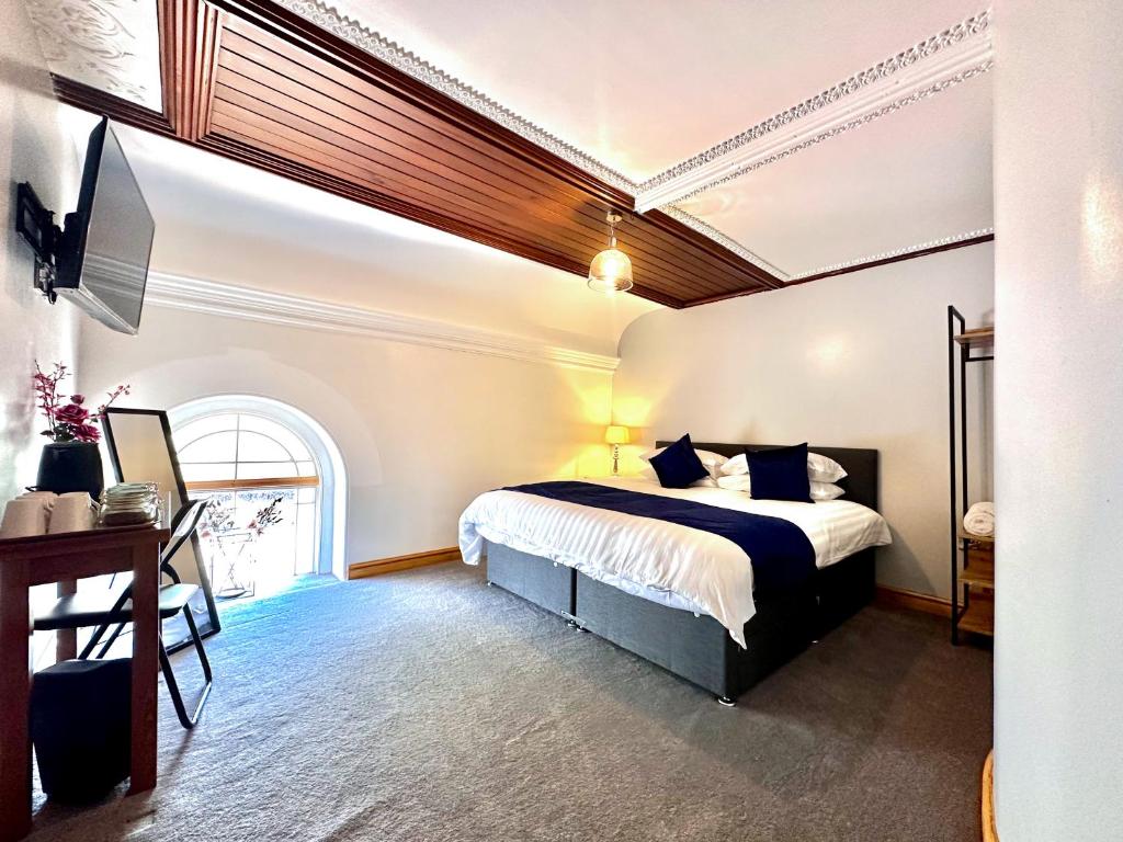 A bed or beds in a room at Pontcysyllte Chapel Tearoom