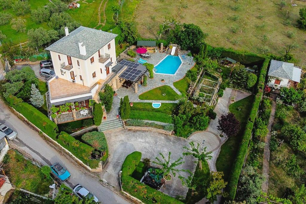 an aerial view of a house with a swimming pool at Iris Villa with Swimming Pool in Áno Lekhónia
