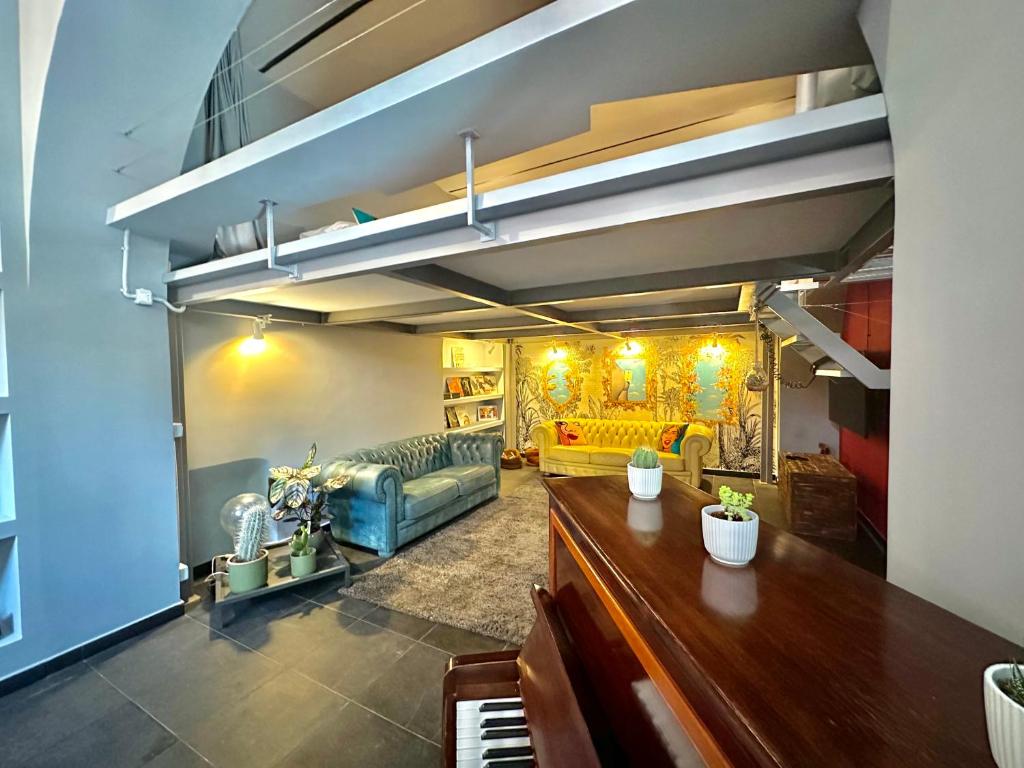 a living room with a couch and a piano at Trastevere Loft in Rome