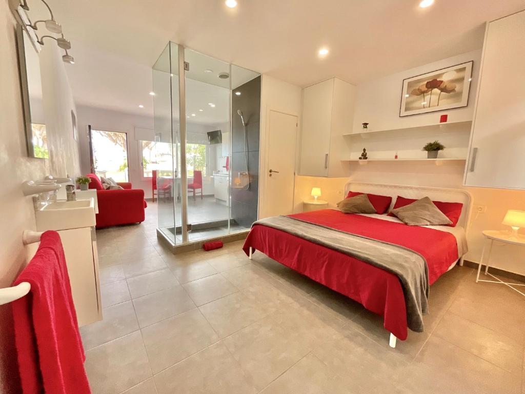 a bedroom with a red bed and a red couch at RedVelvet in Tacoronte