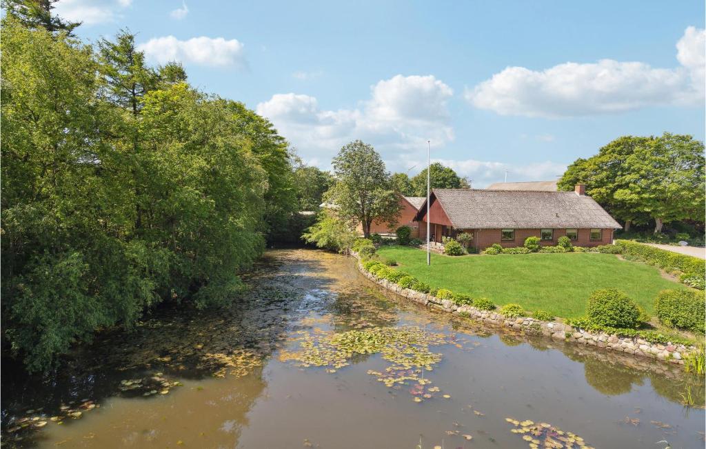 a river with a house in the background at 3 Bedroom Gorgeous Home In Bkmarksbro in Bækmarksbro