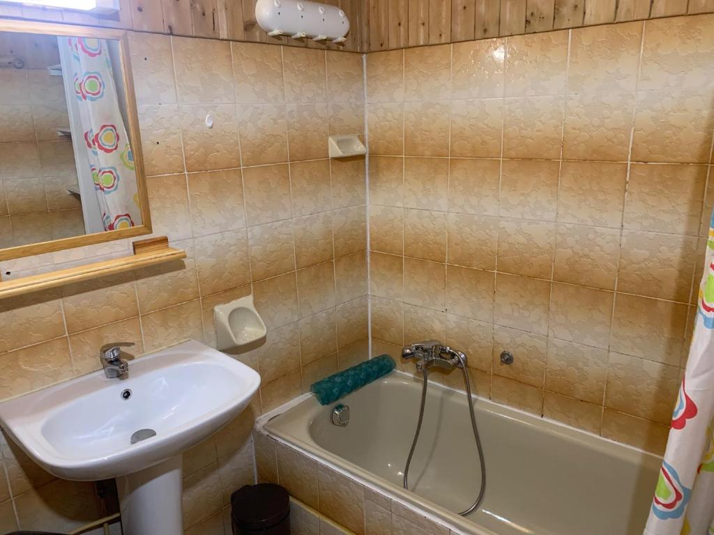 a bathroom with a sink and a bath tub next to a sink at Le p&#39;tit coin montagne 3 in Bonneval-sur-Arc