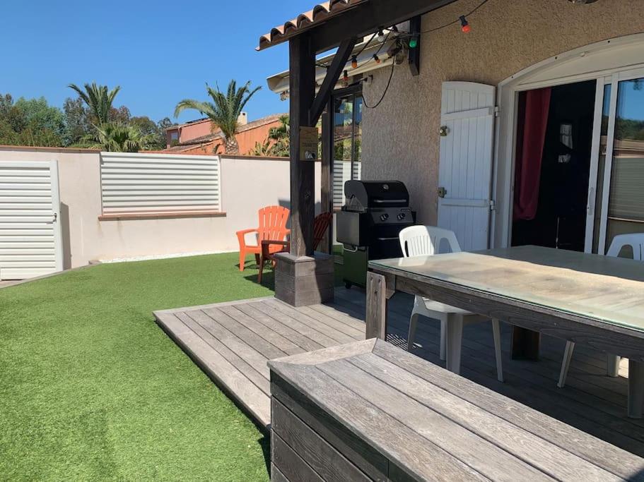 a backyard with a picnic table and a grill at Calme, Confortable, Central in Sainte-Maxime