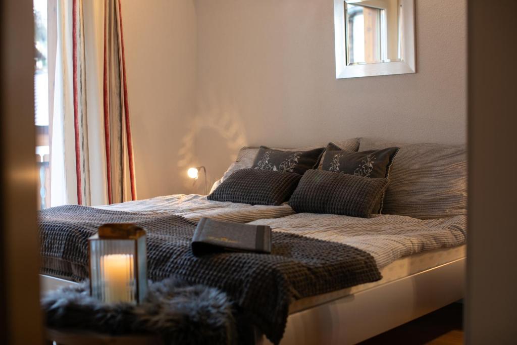 a bedroom with a bed with a candle on it at Residence Chateau in Saas-Fee