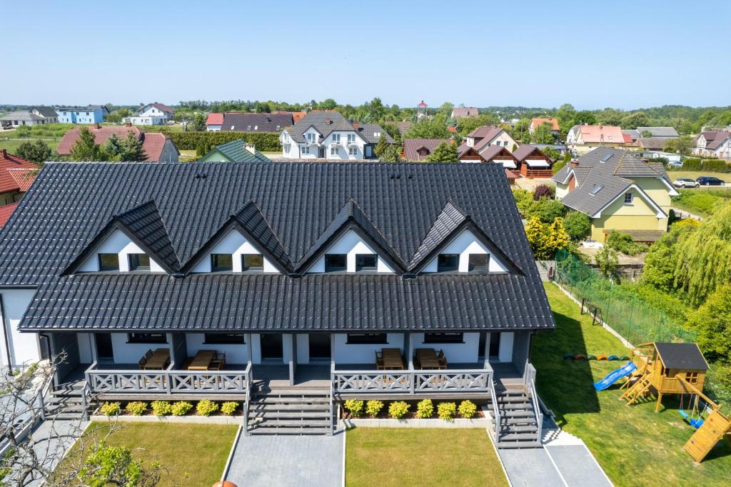 an aerial view of a house with a black roof at Seaside Escape Pet Friendly Apartments Mielenko by Renters in Mielenko