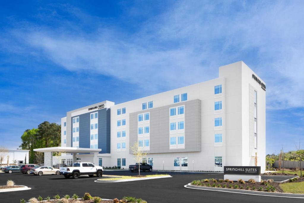 a large white building with cars parked in a parking lot at SpringHill Suites by Marriott Columbia near Fort Jackson in Columbia