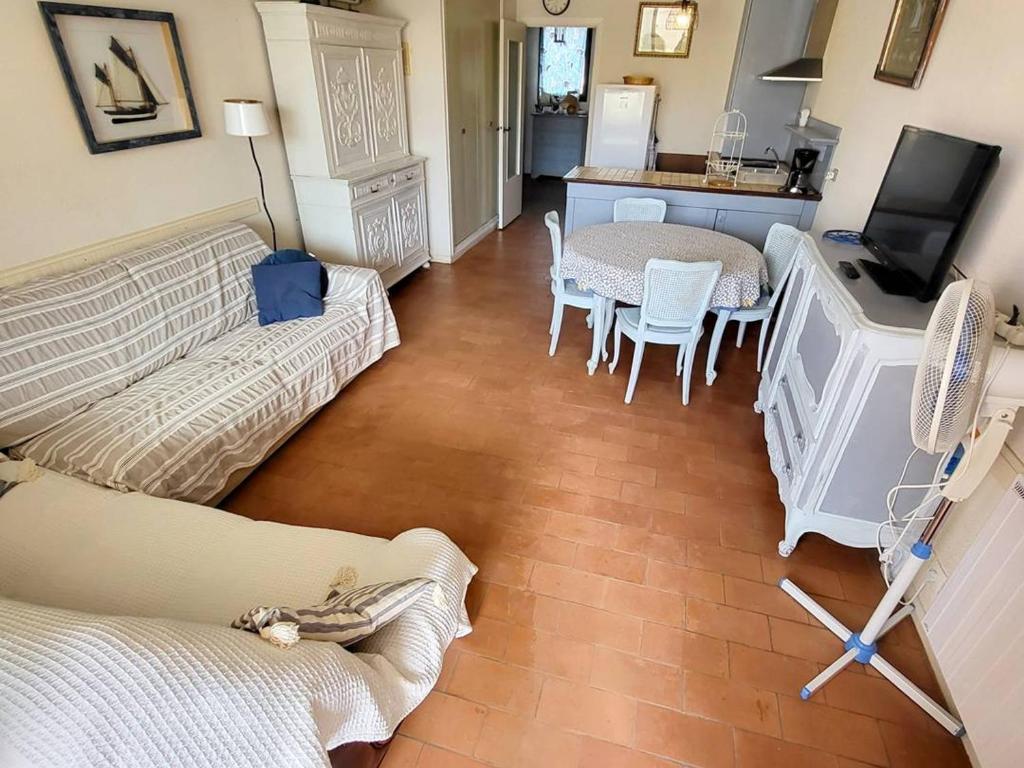 a living room with two couches and a table and a television at Appartement Six-Fours-les-Plages, 2 pièces, 5 personnes - FR-1-316-118 in Six-Fours-les-Plages