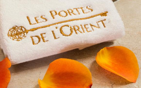 a napkin with the words les portfolios department on it with orange flowers at Riad SPA &quot;Les Portes de l&#39;Orient&quot; TOURS in Tours