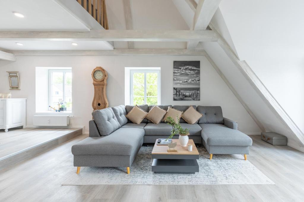 a living room with a couch and a table at Nordisch noble Lebensart WE 1 in Bargum