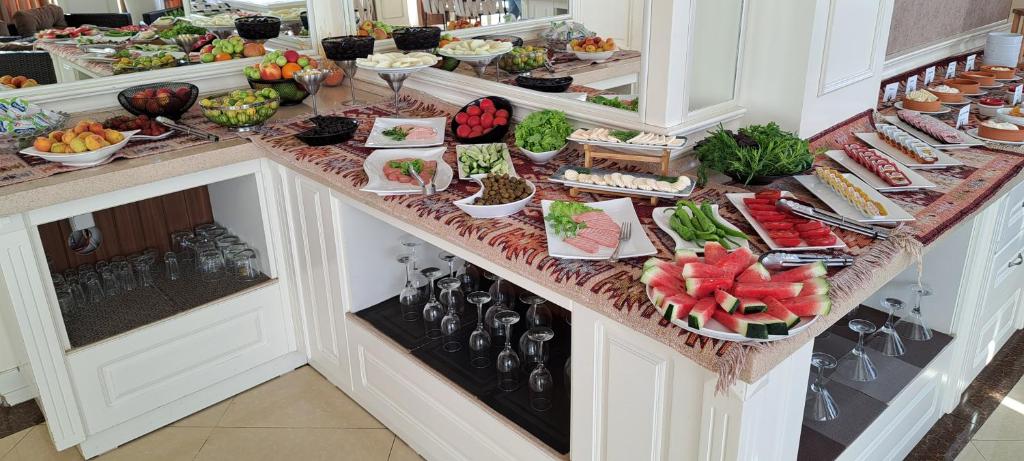a buffet with many plates of food on a counter at Capitol Hotel in Baku