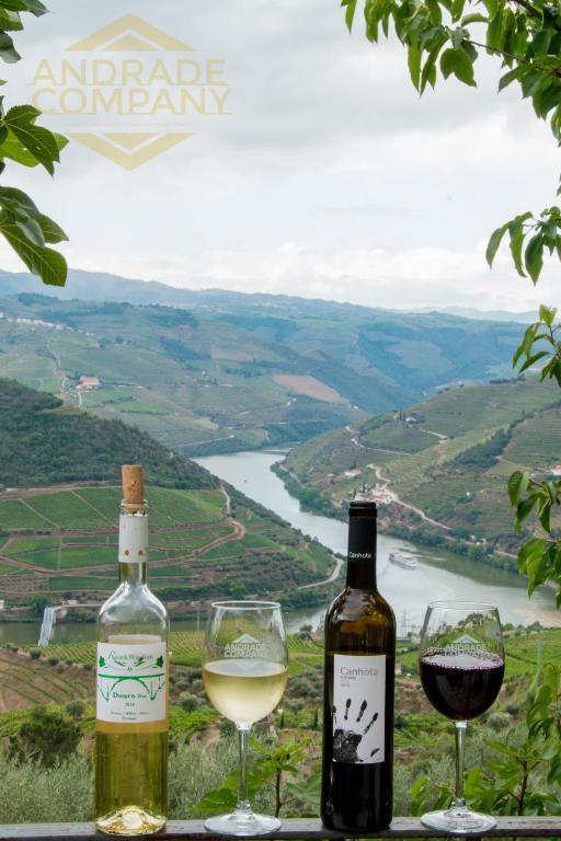 two bottles and two glasses of wine on a ledge at Solar da Calçada in Pinhão