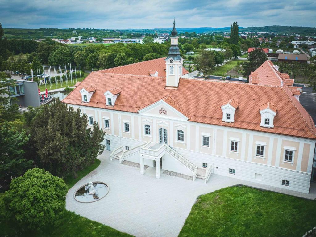 an aerial view of a large building with a clock tower at Schloss Haindorf in Langenlois