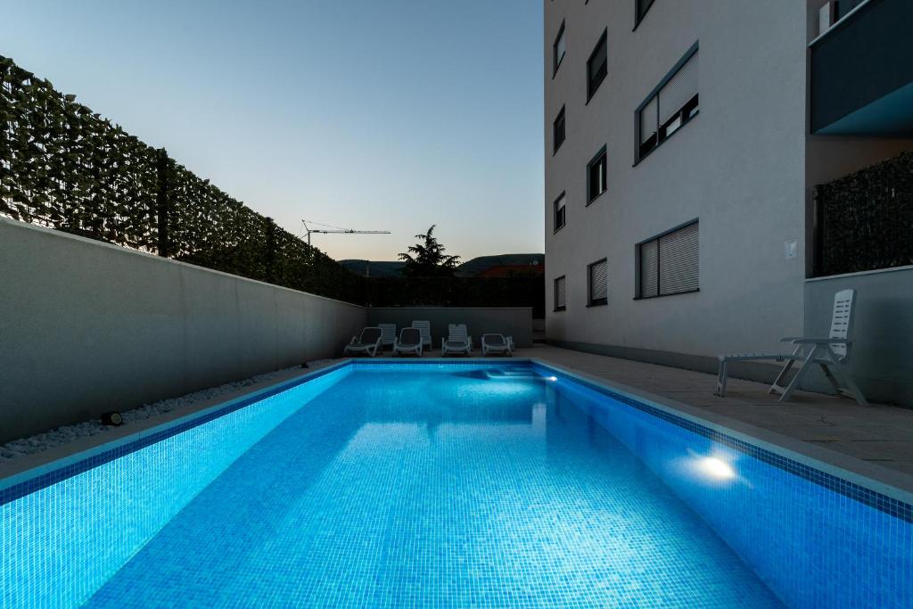 a swimming pool in the middle of a building at Apartments Angelus in Trogir