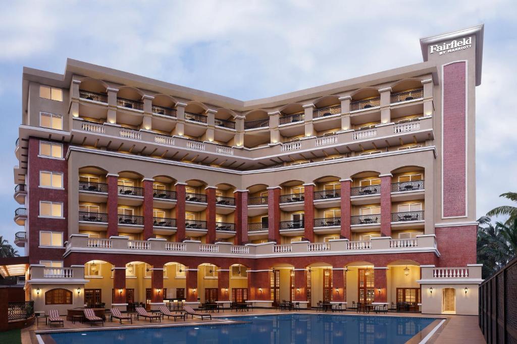 a rendering of the exterior of a hotel with a swimming pool at Fairfield by Marriott Goa Calangute in Calangute