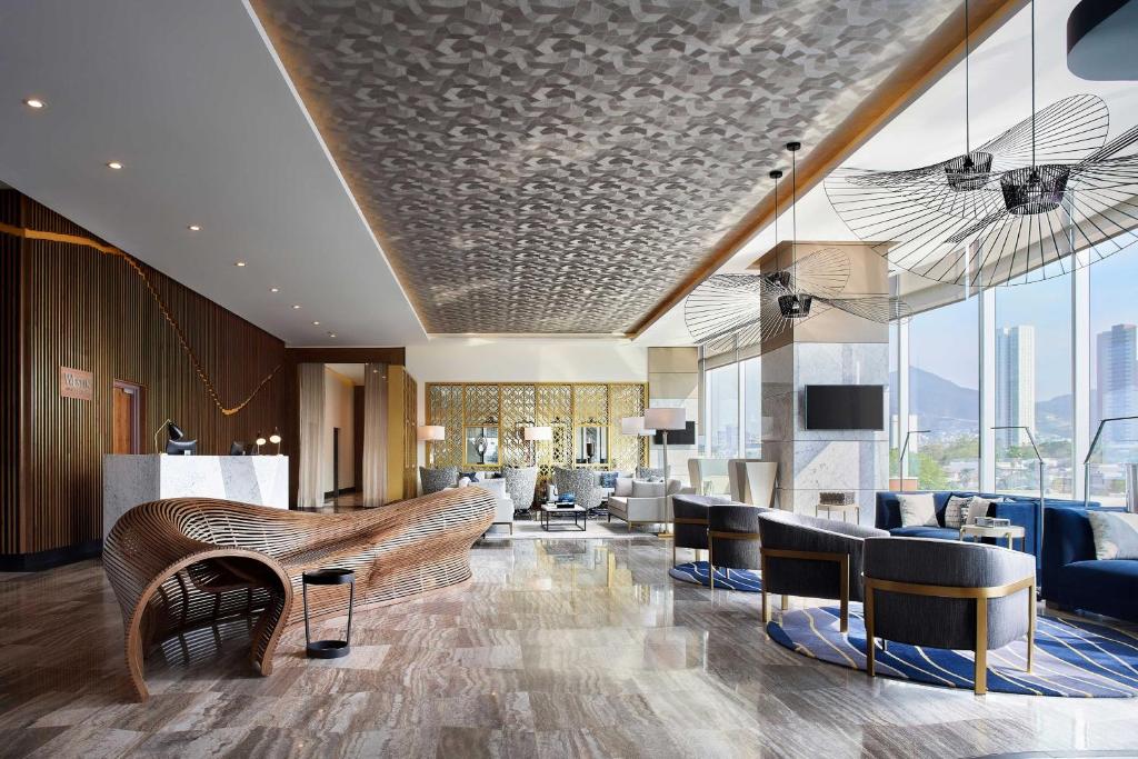 a lobby with a couch and chairs and a table at The Westin Monterrey Valle in Monterrey
