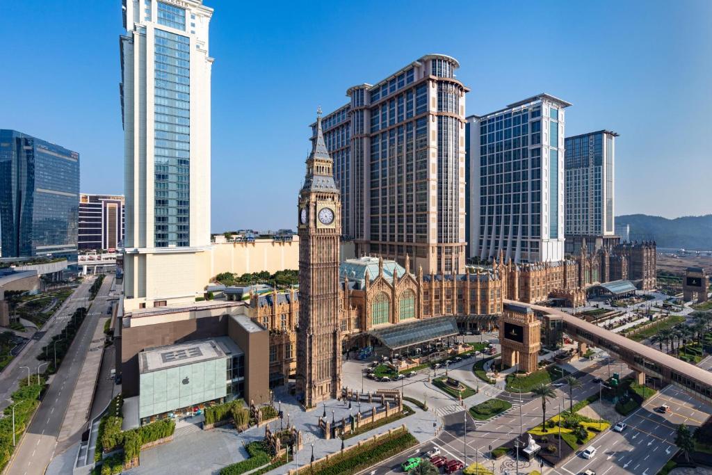 una ciudad con una torre de reloj frente a edificios altos en St. Regis Macao en Macao