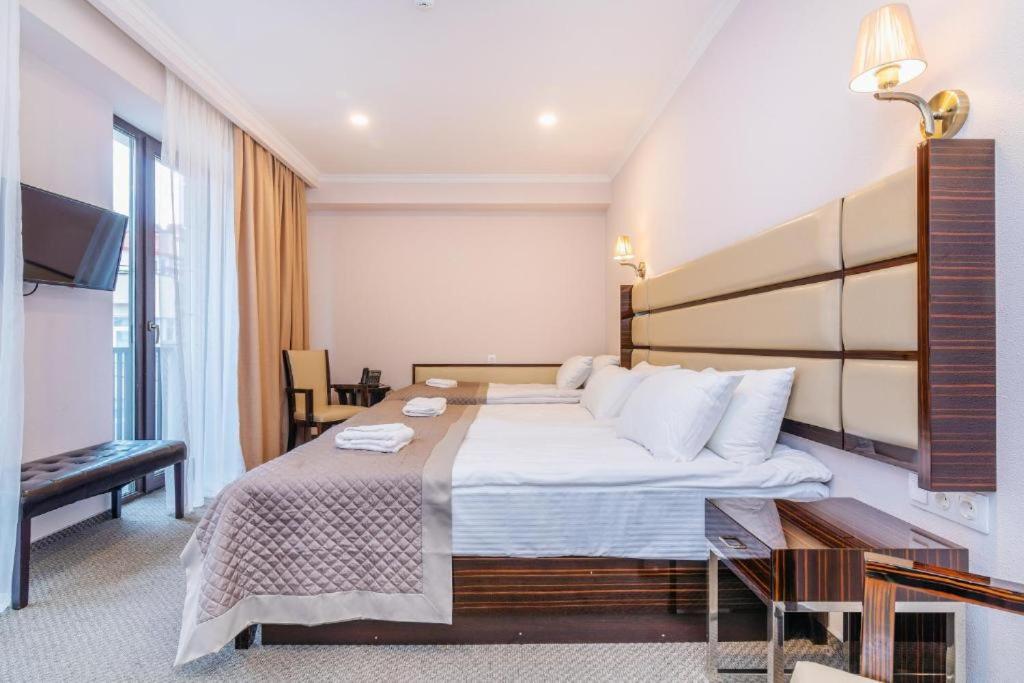 Postel nebo postele na pokoji v ubytování Hotel Genio