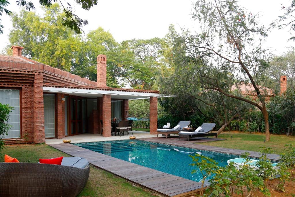 a house with a swimming pool in the yard at The Westin Sohna Resort & Spa in Gurgaon