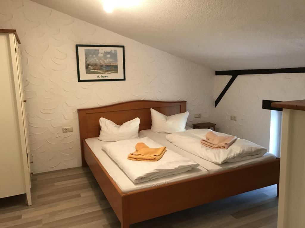 a bedroom with a bed with two towels on it at Fewo 13 Ferienwohnung Ziegenheim auf dem Bauernhof 