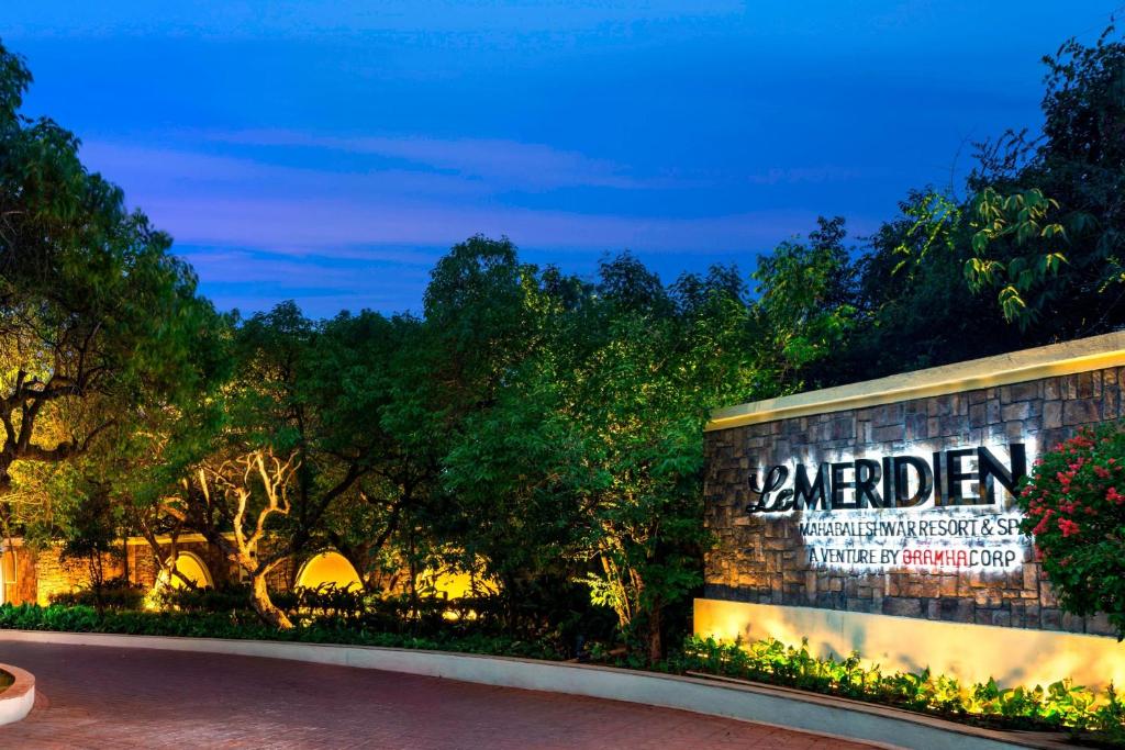 a building with a sign on it at night at Le Meridien Mahabaleshwar Resort & Spa in Mahabaleshwar