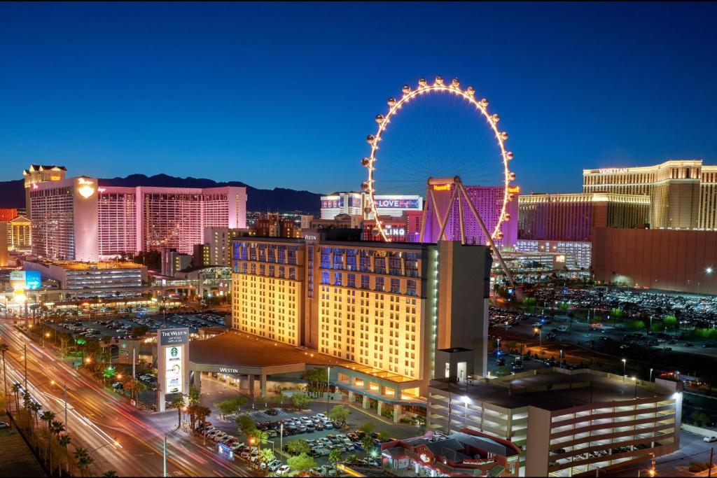 a city skyline with a ferris wheel at night at The Westin Las Vegas Hotel & Spa in Las Vegas