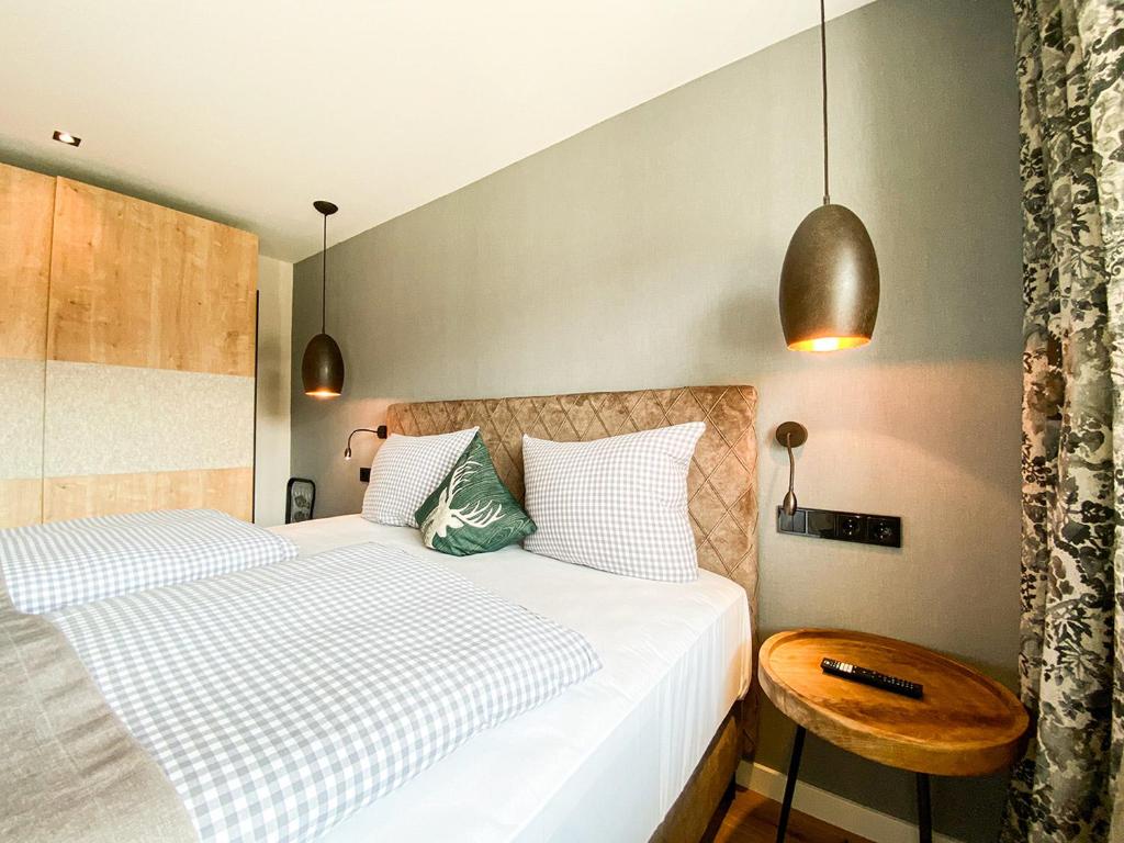 a bedroom with two beds and a table at Bergidyll in Oberstaufen