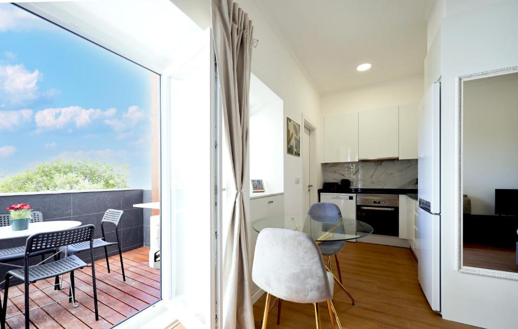 a kitchen and living room with a table and chairs at Apartment Ajuda Tagus (ground floor) in Lisbon