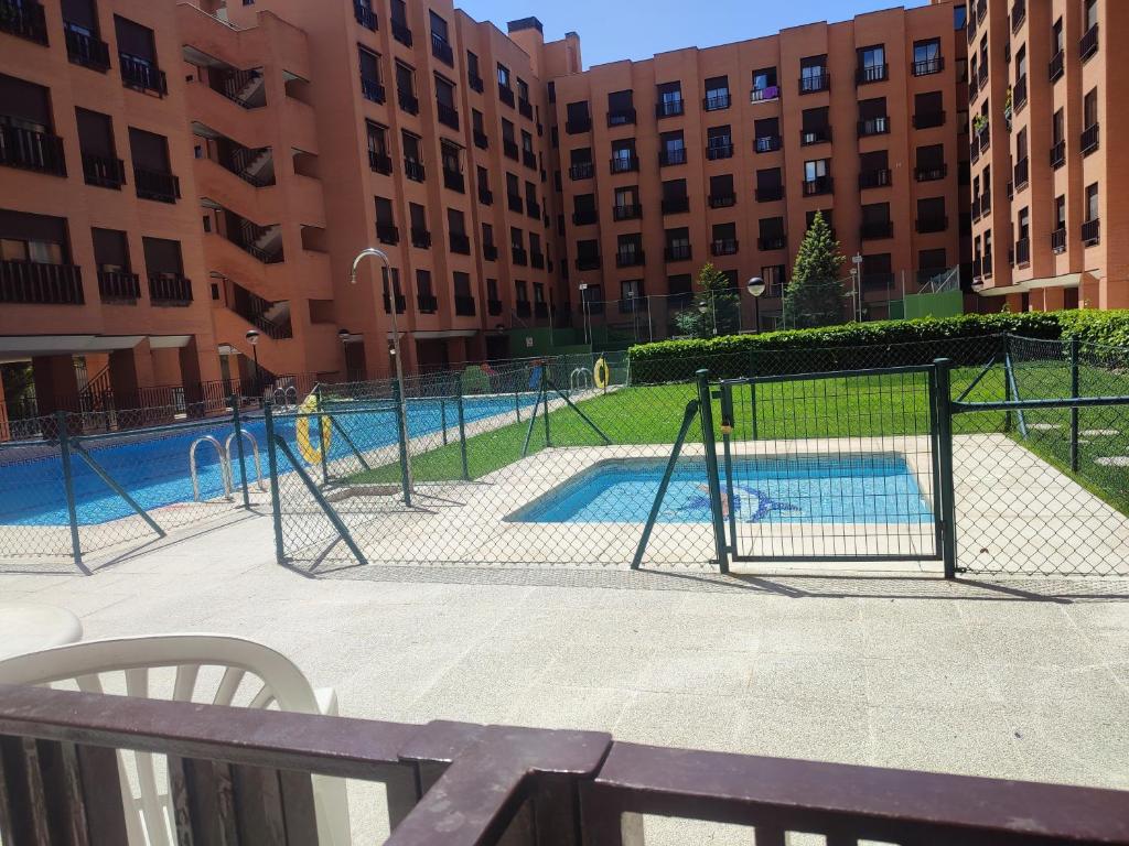 a playground in front of a building with a pool at En Madrid, a unos minutos del aeropuerto airport Barajas, Plenilunio, estadio de fútbol Metropolitano, Feria de Madrid, Clínica Navarra in Madrid