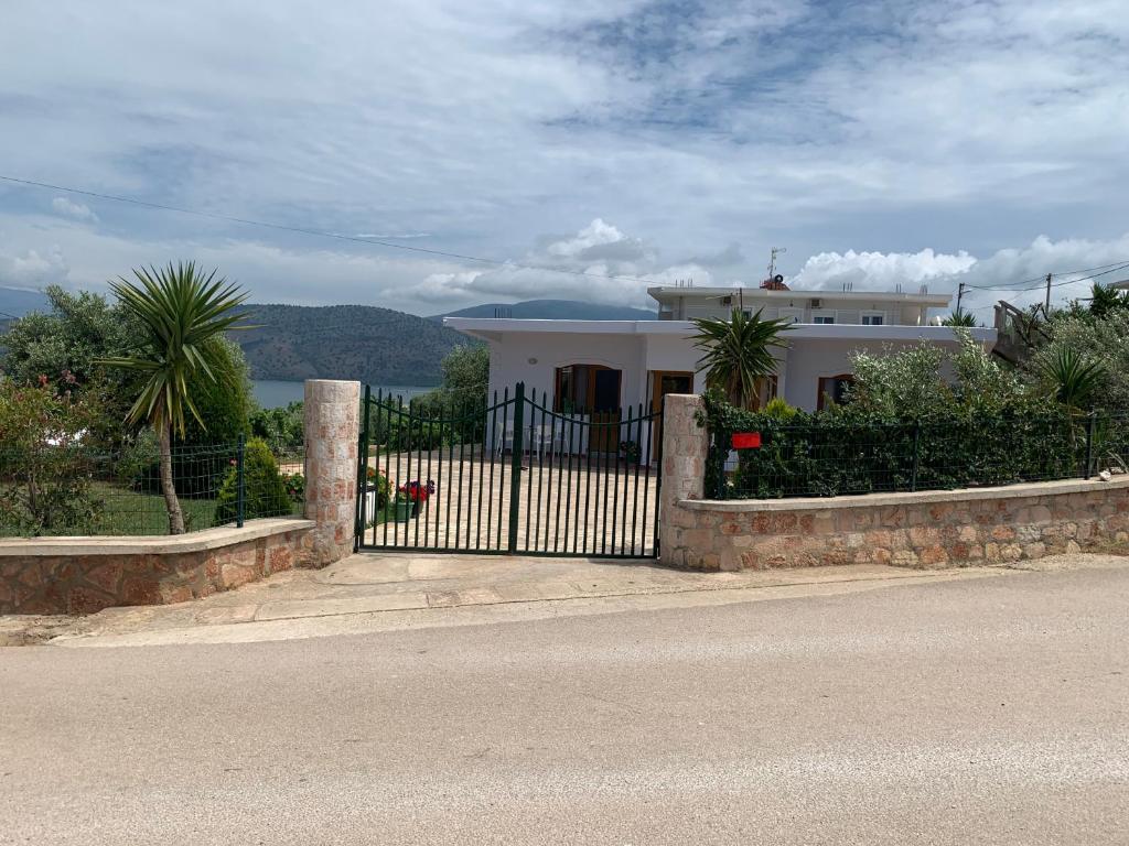 a white house with a gate on the side of the road at Villas Ermali in Ksamil