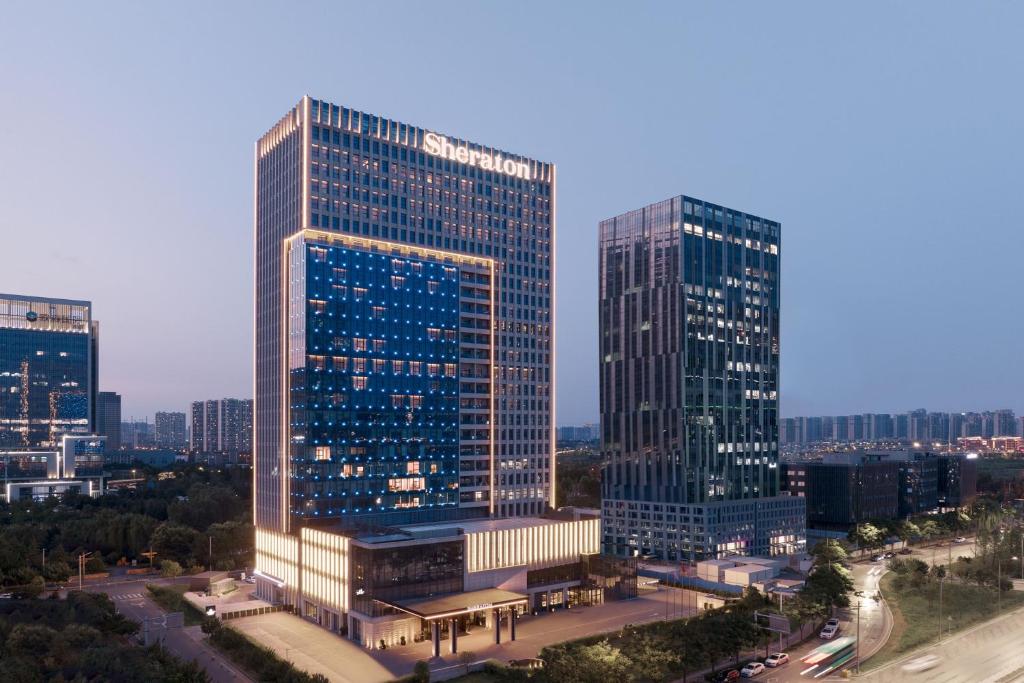 a view of two tall buildings in a city at Sheraton Xi'an South in Xi'an