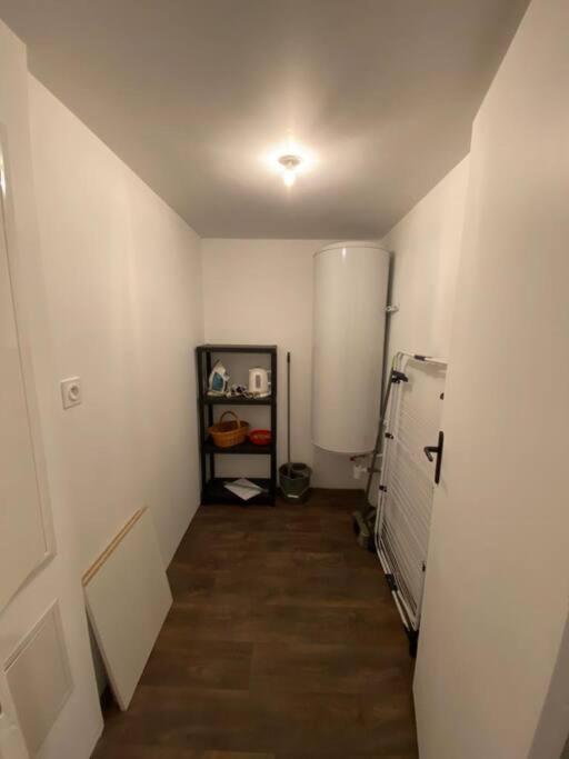 a room with a hallway leading to a room with a refrigerator at REZ DE JARDIN AU COEUR DES PYRENEES in Agos-Vidalos