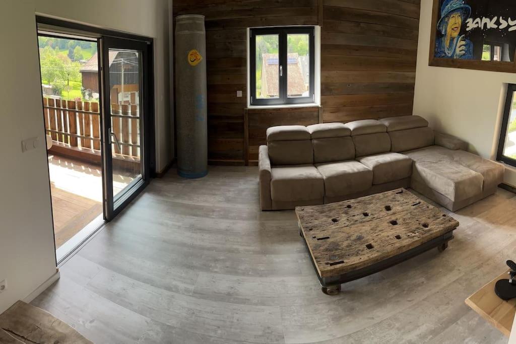 a living room with a couch and a coffee table at Le grenier a foin in Breitenbach-Haut-Rhin