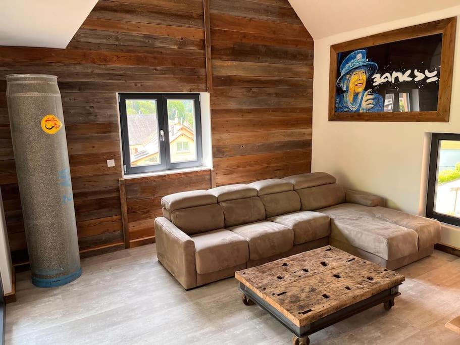 a living room with a couch and a coffee table at Le grenier a foin in Breitenbach-Haut-Rhin