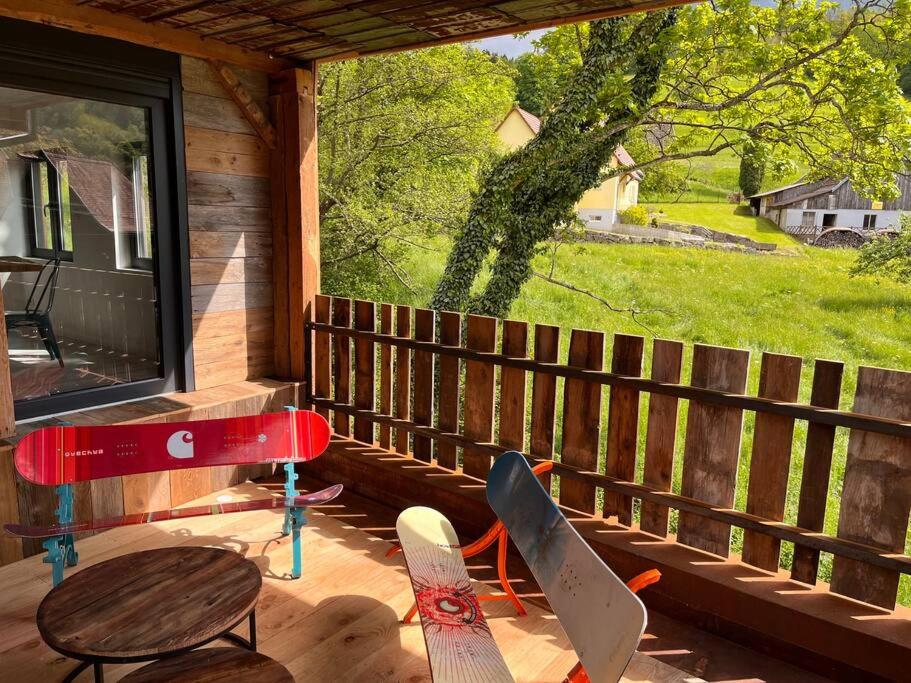 a porch with a table and four snowboards on it at Le grenier a foin in Breitenbach-Haut-Rhin