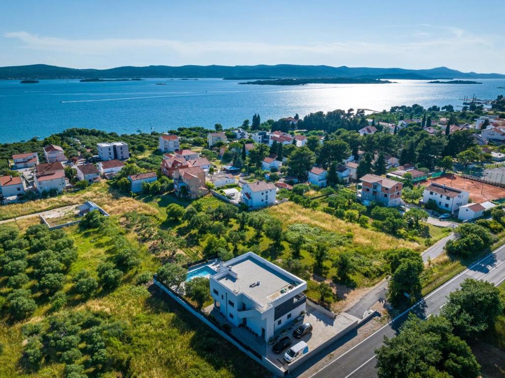 an aerial view of a city and the water at CROWONDER Sun Dance Apartments with Heated Swimming Pool Seaview and Garden in Sveti Filip i Jakov