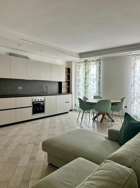 a living room with a couch and a table at Appartamento Borgomarina in Cervia
