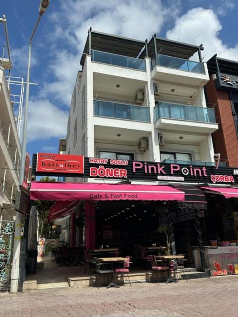 a building with a pink point sign in front of it at PİNK POİNT APART in Didim