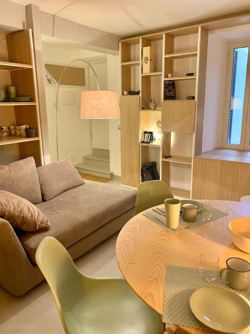 a living room with a couch and a table at Miini loft di pregio a Roma Nord- Ponte Milvio in Rome
