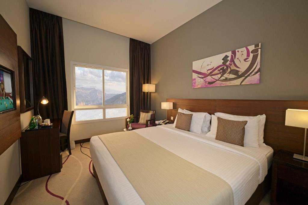 Postel nebo postele na pokoji v ubytování Action Hotel Ras Al Khaimah
