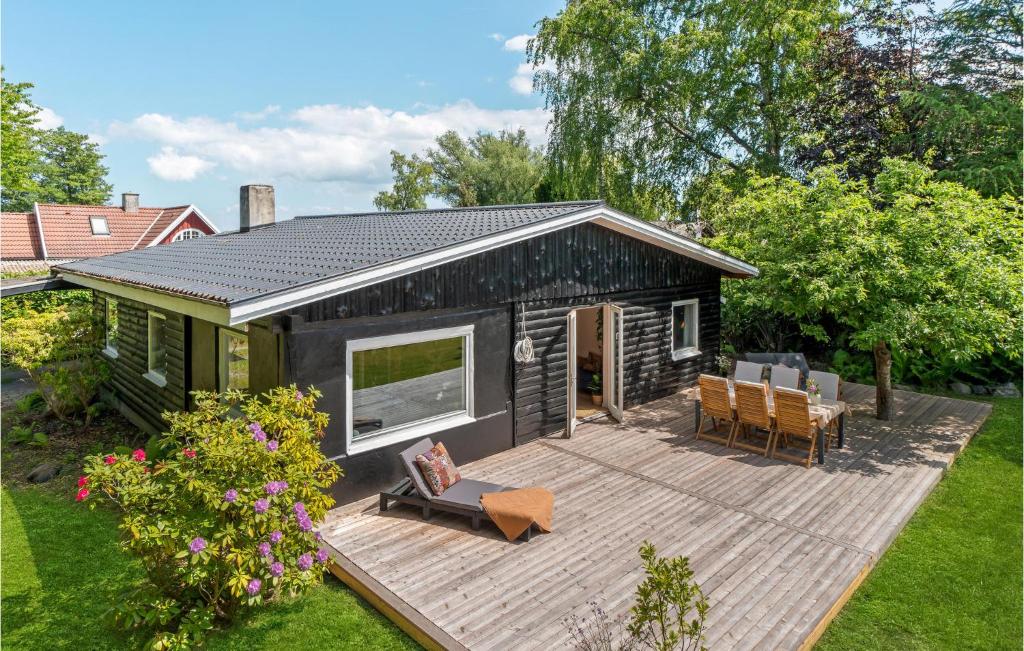 a tiny house with a deck in a yard at Amazing Home In Fredensborg With Wifi in Fredensborg